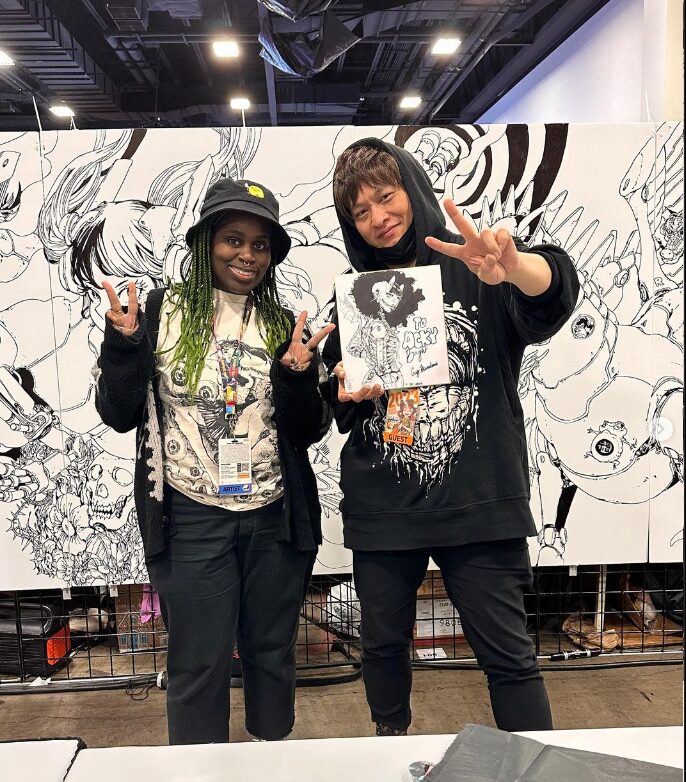 Gigi standing with Acky Bright